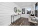 Sunroom with wood floors, white walls and a stylish console table at 304 Gold Hill Ave, Rockwell, NC 28138