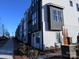 Modern townhome exterior featuring a combination of gray siding and brick accents with a Chambray community sign at 3614 S Tryon St # 18, Charlotte, NC 28217