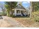 Traditional home featuring a cozy front porch, lovely front yard and mature trees at 507 W 2Nd Ave, Gastonia, NC 28052