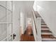 Inviting hallway with hardwood floors and stairs leading to the upper level at 507 W 2Nd Ave, Gastonia, NC 28052