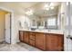 Double vanity bathroom with dark wood cabinets and a large mirror at 5734 Morris Hunt Dr, Fort Mill, SC 29708