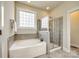 Bathroom with a large soaking tub and a separate glass shower at 5734 Morris Hunt Dr, Fort Mill, SC 29708