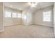 Bright bedroom featuring neutral carpeting and multiple windows at 5734 Morris Hunt Dr, Fort Mill, SC 29708