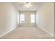 Well-lit bedroom featuring neutral walls and carpet at 5734 Morris Hunt Dr, Fort Mill, SC 29708