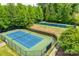 Two tennis courts surrounded by lush trees at 5734 Morris Hunt Dr, Fort Mill, SC 29708