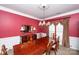 Formal dining room with large table, chandelier, and rich wall color at 625 Circle Trace Rd, Monroe, NC 28110