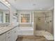 Bathroom with soaking tub, walk in shower, and granite vanity at 9507 Inverness Bay Rd, Charlotte, NC 28278