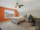 Bedroom with orange accent wall and built-in workspace at 9507 Inverness Bay Rd, Charlotte, NC 28278