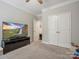 Spacious bedroom with large TV and double door closet at 9507 Inverness Bay Rd, Charlotte, NC 28278