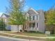 Two-story home with gray siding, stone accents, and a two-car garage at 9507 Inverness Bay Rd, Charlotte, NC 28278