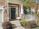 Inviting front porch with stone pillars and white rocking chairs at 9507 Inverness Bay Rd, Charlotte, NC 28278