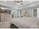 Main bedroom with large TV, dresser, and ensuite bathroom at 9507 Inverness Bay Rd, Charlotte, NC 28278