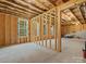 Unfinished basement with framed walls, windows, and plumbing at 9507 Inverness Bay Rd, Charlotte, NC 28278