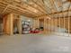 Unfinished basement area with exposed framing and concrete floor at 9507 Inverness Bay Rd, Charlotte, NC 28278