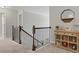 Upstairs hall with wooden railing and decorative shelving at 9507 Inverness Bay Rd, Charlotte, NC 28278