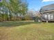 Large, well-maintained backyard with patio, screened porch, and mature trees at 111 Alberta Ave, Belmont, NC 28012
