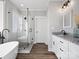 Bright bathroom with modern tub, shower, double vanities, and hardwood floors at 111 Alberta Ave, Belmont, NC 28012