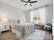 Comfortable bedroom with neutral tones, a plush bed, large window, and stylish decor at 111 Alberta Ave, Belmont, NC 28012