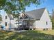 Back exterior view of home with a screened porch and outdoor dining area at 111 Alberta Ave, Belmont, NC 28012