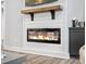 Close-up of modern fireplace with shiplap, wood mantel and hearth, adding warmth to the living room at 111 Alberta Ave, Belmont, NC 28012