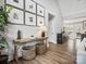 Open foyer with hardwood floors, a stylish bench, and decorative wall art at 111 Alberta Ave, Belmont, NC 28012