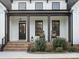 Inviting front porch with rocking chairs, brick steps, and a stylish black front door at 111 Alberta Ave, Belmont, NC 28012