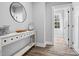 Bright hallway featuring a decorative table, elegant mirror, and doorway leading to another room at 111 Alberta Ave, Belmont, NC 28012