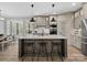 Charming kitchen island with barstool seating, modern appliances, and pendant lighting at 111 Alberta Ave, Belmont, NC 28012
