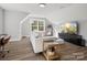 Open living room with vaulted ceiling, large window, modern furniture, and TV setup at 111 Alberta Ave, Belmont, NC 28012