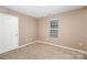 Simple bedroom with neutral walls and carpeted floor at 119 Lookout Point Pl, Mooresville, NC 28115