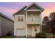 Two-story house with a neutral color scheme and a balcony at 119 Lookout Point Pl, Mooresville, NC 28115