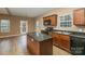 Kitchen boasts granite countertops, dark wood cabinets, and an island at 119 Lookout Point Pl, Mooresville, NC 28115
