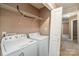 Laundry closet with washer, dryer, and shelving at 119 Lookout Point Pl, Mooresville, NC 28115