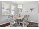 Bright dining area featuring a charming distressed table set, large windows, and stylish light fixture at 1969 Tablerock Dr, Lake Wylie, SC 29745