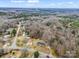 An aerial view showcases the property's neighborhood, and location near a vast expanse of trees and natural landscape at 2319 Tin Mine Rd, Lincolnton, NC 28092