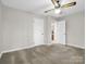 Neutrally-carpeted bedroom featuring a ceiling fan and two closet doors at 2319 Tin Mine Rd, Lincolnton, NC 28092