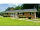 Charming brick ranch home with a well-maintained lawn, trimmed hedges, and a cozy front entrance at 2319 Tin Mine Rd, Lincolnton, NC 28092