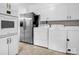 Well-lit laundry area featuring modern white cabinets and stainless steel refrigerator at 2319 Tin Mine Rd, Lincolnton, NC 28092