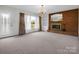 Inviting living room with fireplace, large windows, and chandelier; perfect for relaxing at 2319 Tin Mine Rd, Lincolnton, NC 28092