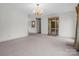 Open living area featuring a classic chandelier, display cabinet, and neutral carpeting at 2319 Tin Mine Rd, Lincolnton, NC 28092