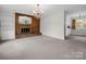 Bright living room showcasing a brick fireplace, built-in shelving, and elegant chandelier at 2319 Tin Mine Rd, Lincolnton, NC 28092