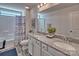 Well-lit bathroom featuring a double sink vanity with granite countertop, and a shower and tub combination at 320 Coronado Ave, Matthews, NC 28104