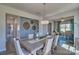 Elegant dining room with modern lighting, a stylish accent wall, and views into the living area at 320 Coronado Ave, Matthews, NC 28104