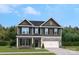 Charming two-story home with stone accents, a well-manicured lawn and attractive landscaping at 320 Coronado Ave, Matthews, NC 28104