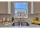 Bright kitchen sink area with white cabinets, granite countertops, and a pleasant view at 320 Coronado Ave, Matthews, NC 28104