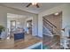 Open-concept living area showcasing hardwood floors, a staircase, and plenty of natural light at 320 Coronado Ave, Matthews, NC 28104
