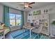 Bright home office with a desk, chairs, bookshelf, and a view of the outdoors through a large window at 320 Coronado Ave, Matthews, NC 28104