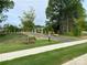 Landscaped entrance to Harrisburg Village with paved pathway and sidewalks at 4107 Black Ct # 166, Harrisburg, NC 28075