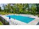 Community pool with plenty of lounge chairs and umbrellas at 4107 Black Ct # 166, Harrisburg, NC 28075