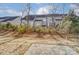 Private backyard with stone patio and partial view of neighboring homes at 4113 Black Ct # 167, Harrisburg, NC 28075